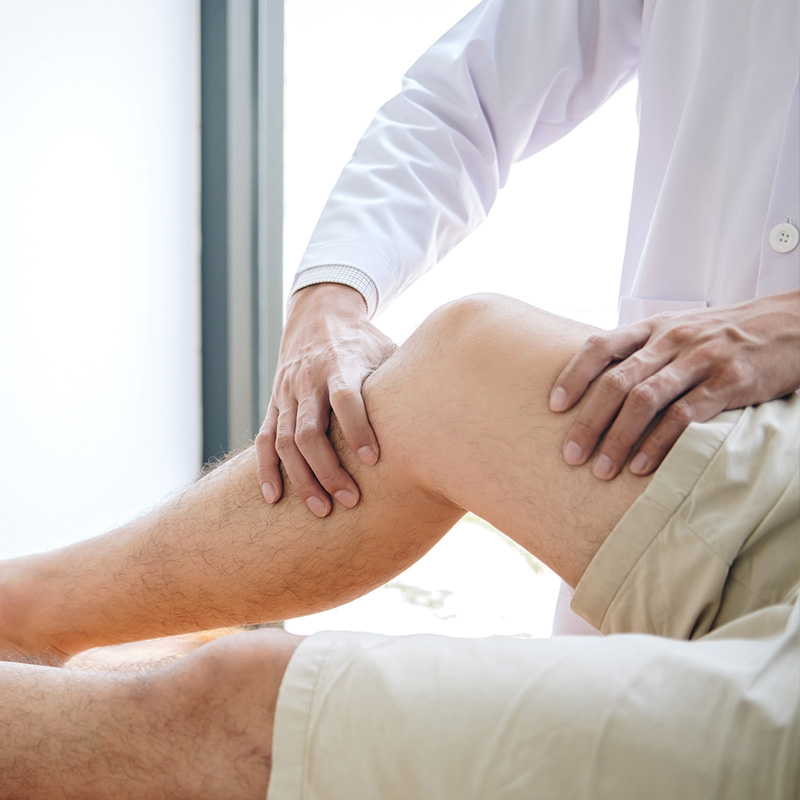 Orthopedic doctor examining a patients knee