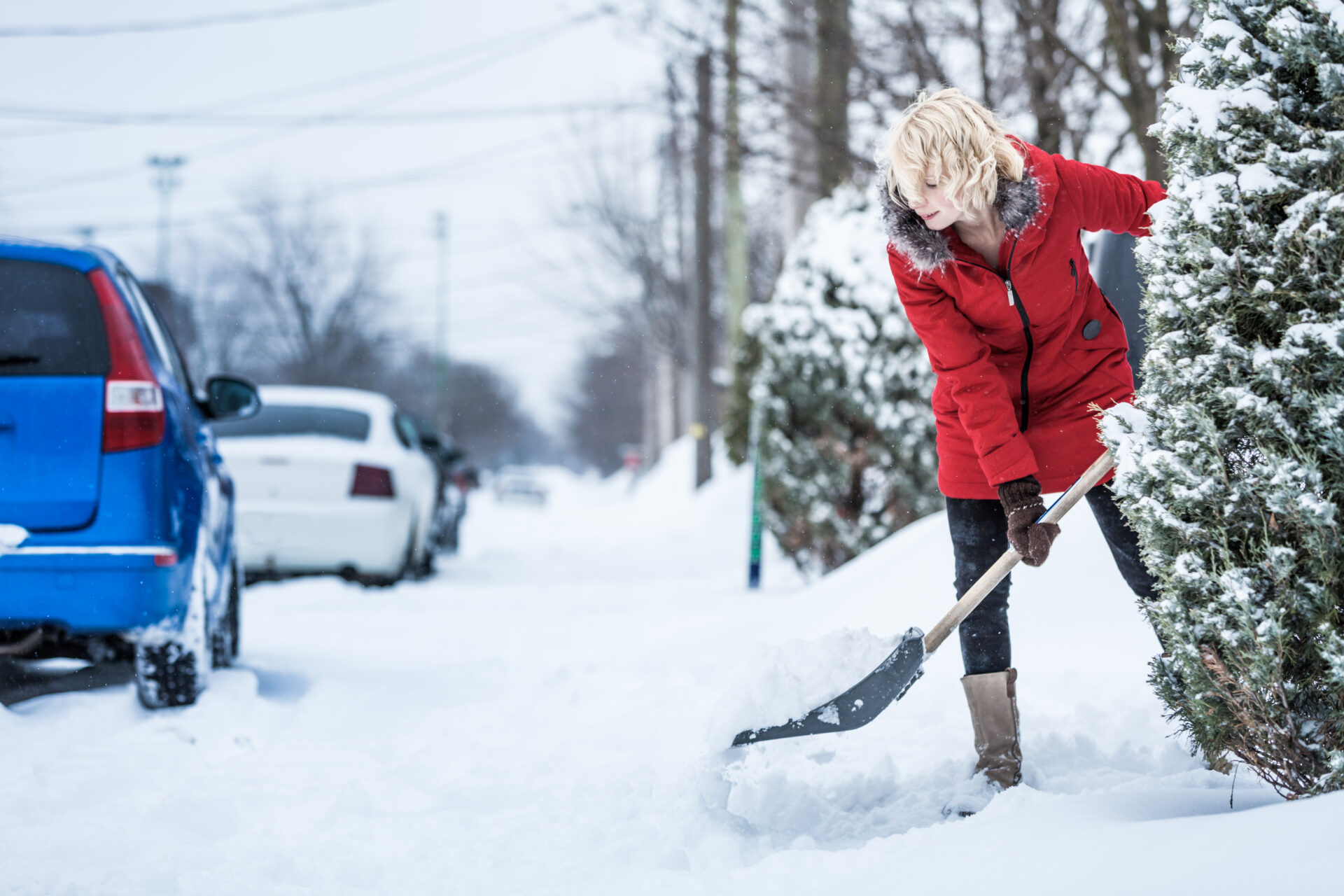 A person shovels snow, working every four hours to keep up with the accumulations to get good exercise while reducing the risk of injury.
